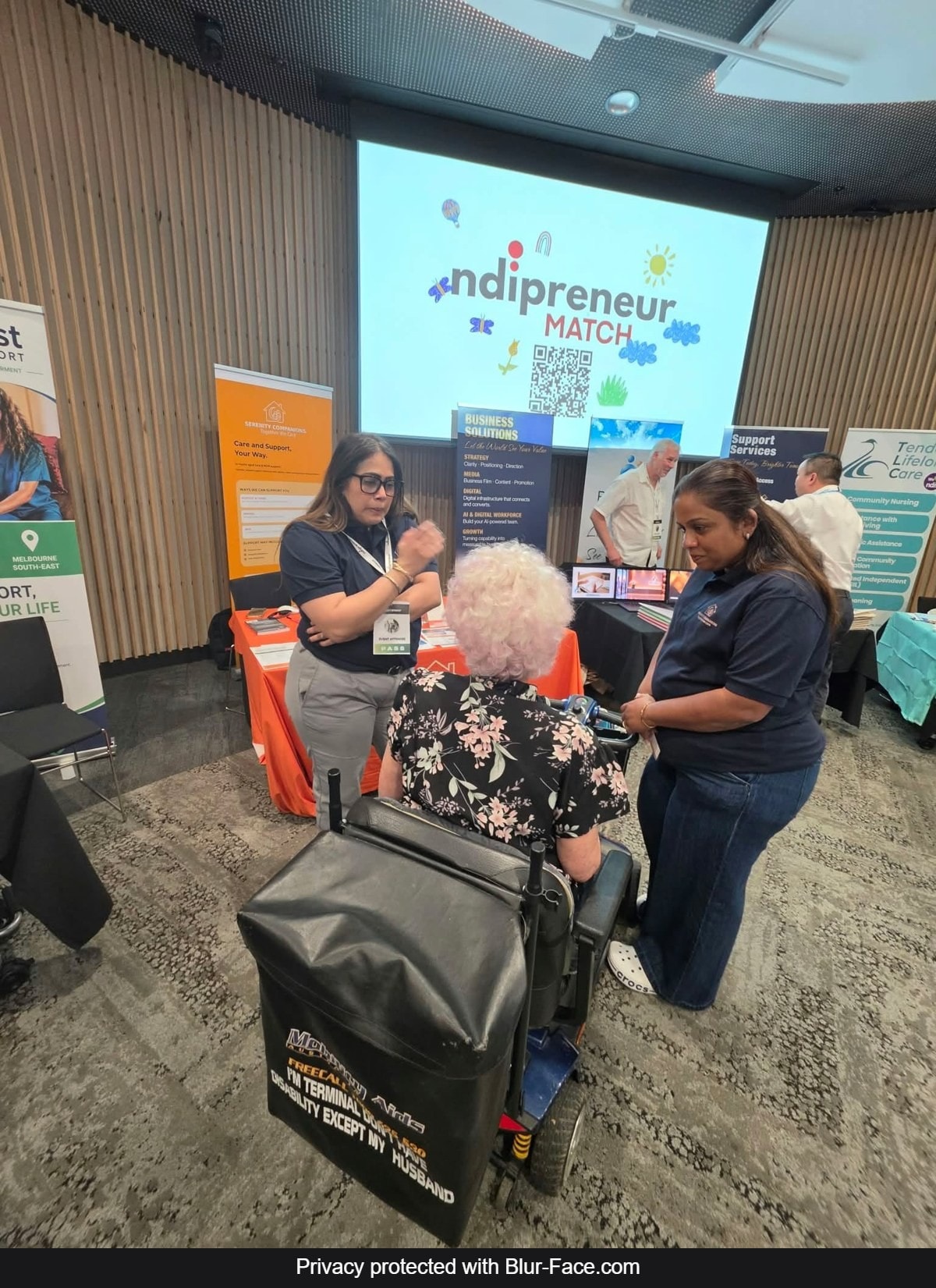 Serenity Companions support workers talking with a visitor at the Melbourne NDIS Expo 2026